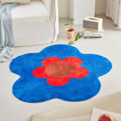 Tapis floral bleu aux formes organiques, sublimant un espace moderne grâce à son design coloré et graphique.
