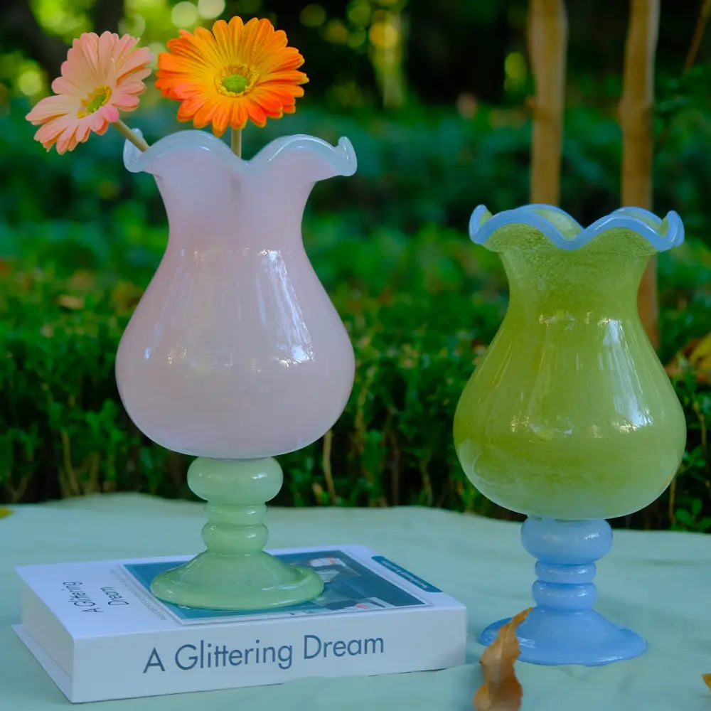 Vase with design rose à pied vert, silhouette élégante et décorative pour un intérieur lumineux.