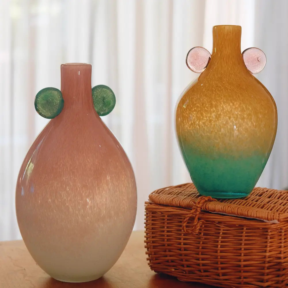 Duo de vases with designs en verre soufflé artisanal – version framboise menthe et version ambre vert, création décorative élégante et contemporaine pour la maison.