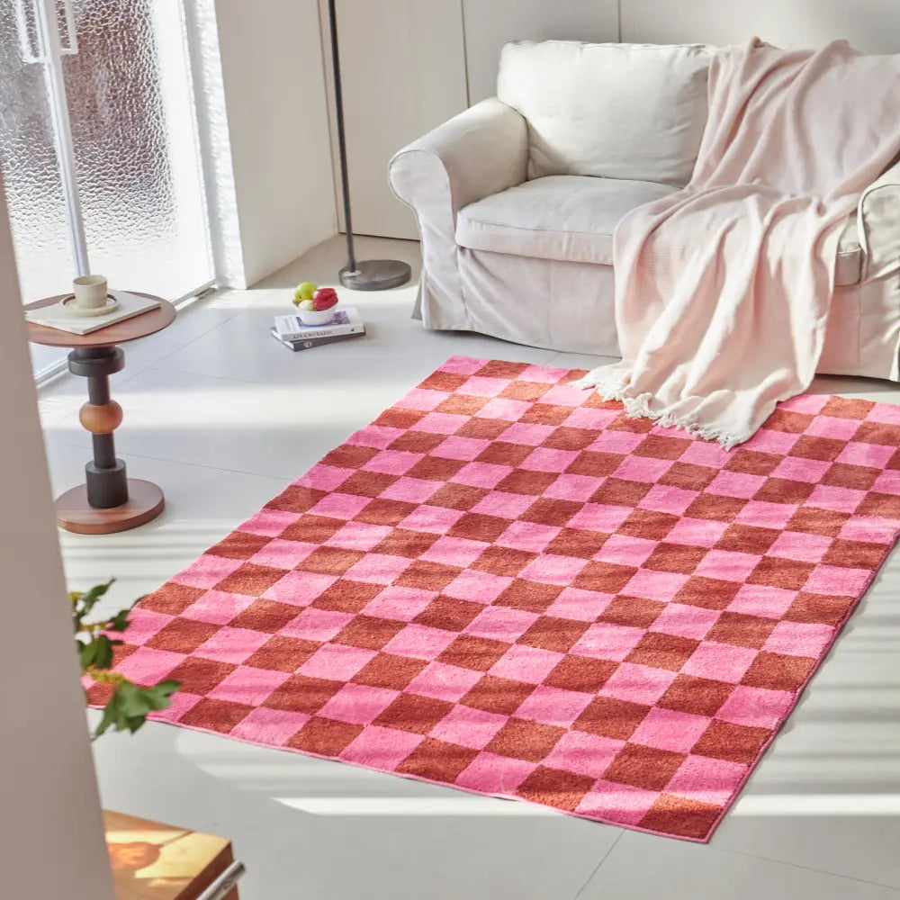 Grand tapis à carreaux rose au motif vichy, parfait pour créer une ambiance moderne et chaleureuse dans un espace de vie.